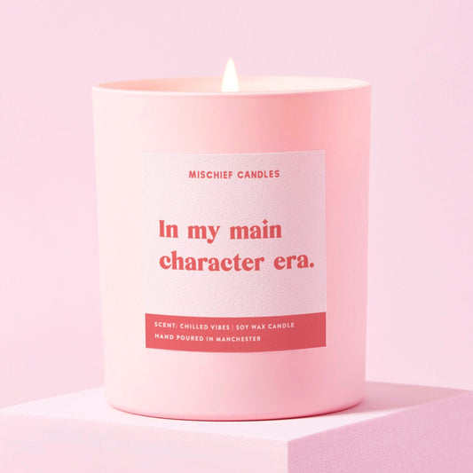 Pink candle with a label on a pink background