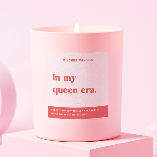 Pink candle with a label on a pink background