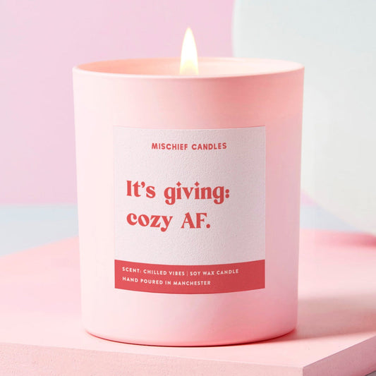 Pink candle with a label on a light pink background