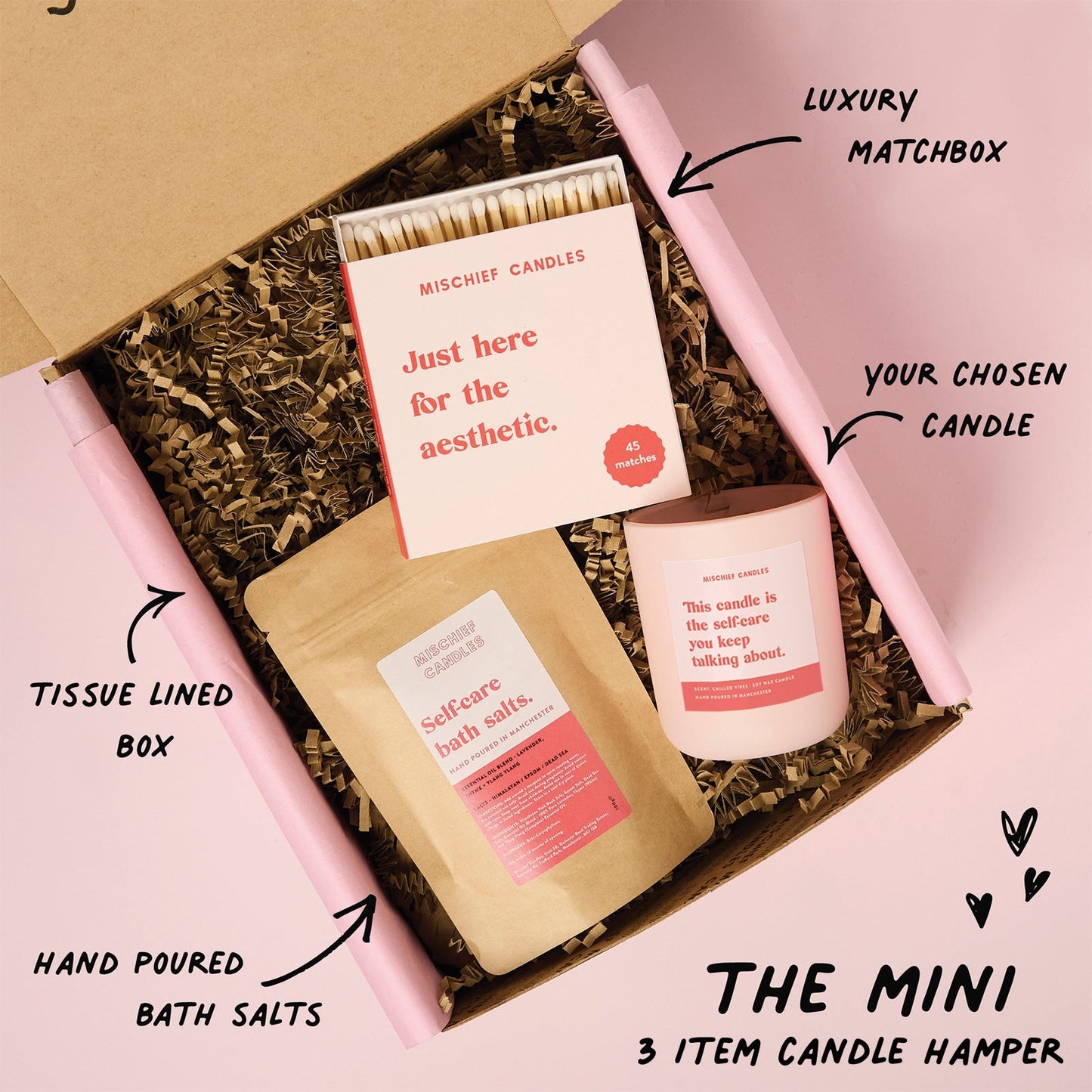 Candle hamper with matchbox, bath salts, and candle in a tissue-lined box.
