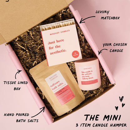 Candle hamper with matchbox, bath salts, and candle in a tissue-lined box.