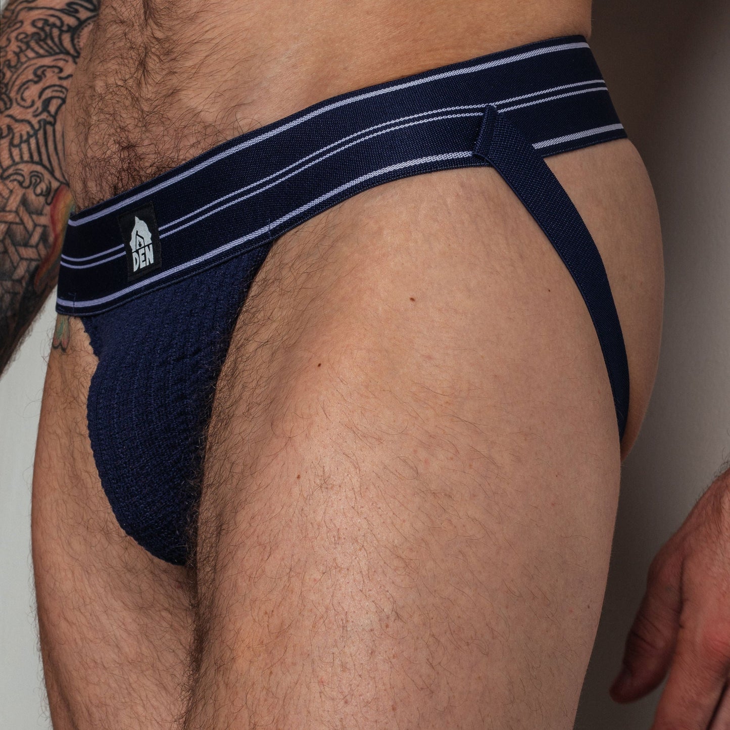 Navy men's underwear with white stripes on a plain background