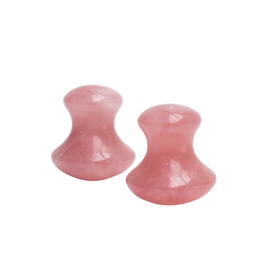 Two pink stone plugs on a white background
