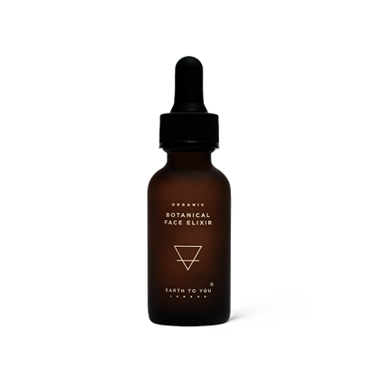Brown bottle of organic botanical face elixir with dropper on a white background