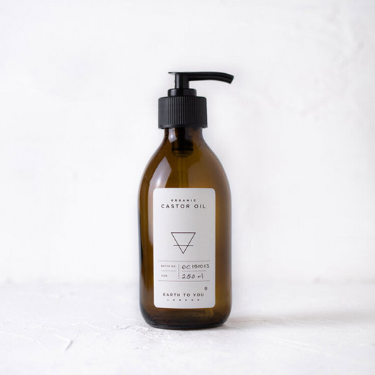 Brown bottle with pump and white label on a white background