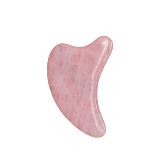 Pink gua sha tool on a white background