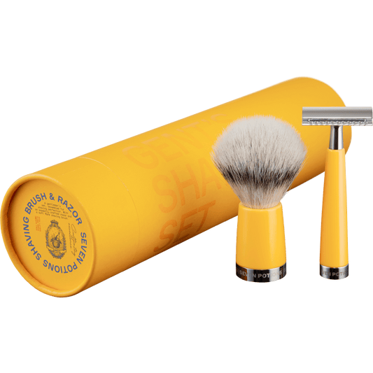Yellow shaving brush and razor set with a cylindrical yellow container on a black background