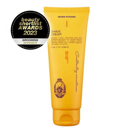 Yellow tube of shave cream with 'Seven Potions' branding on a black background, featuring an award badge for 'Grooming Winner' at the beauty shortlist awards 2023.