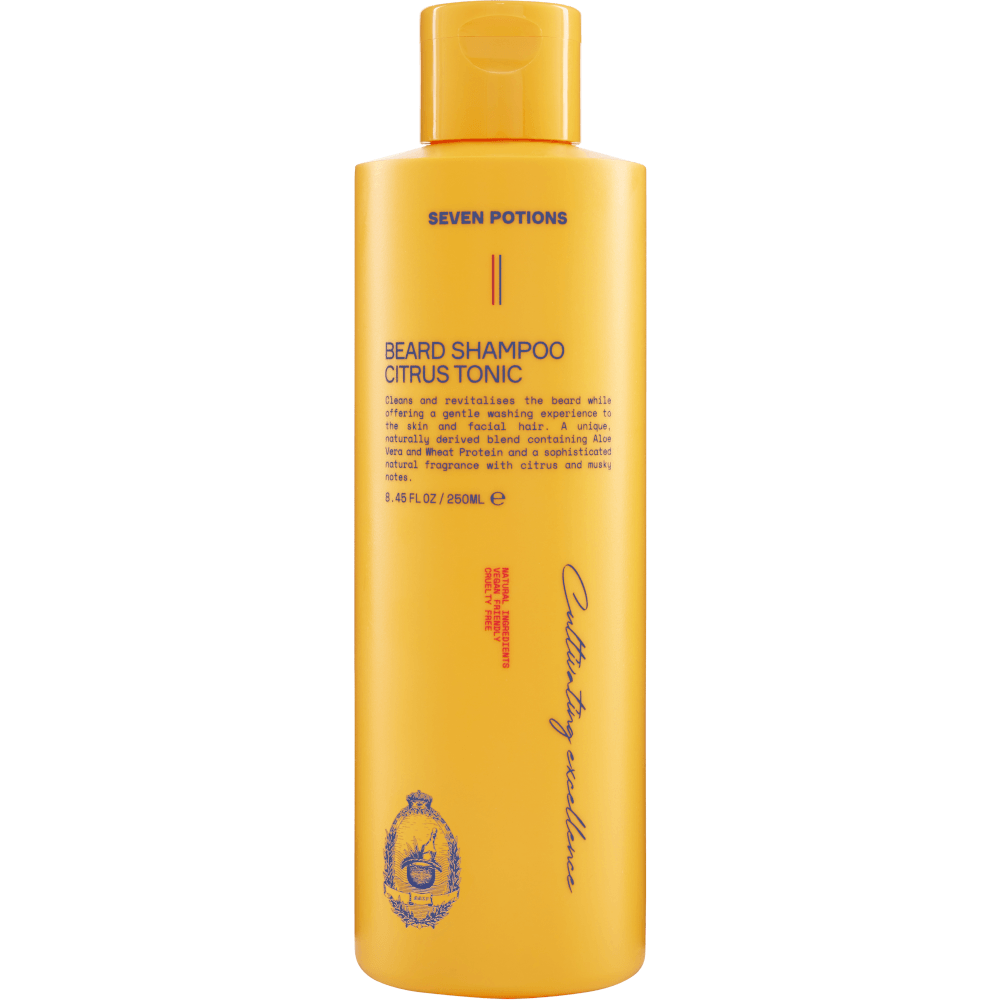 Yellow bottle of Seven Potions beard shampoo on a gray background