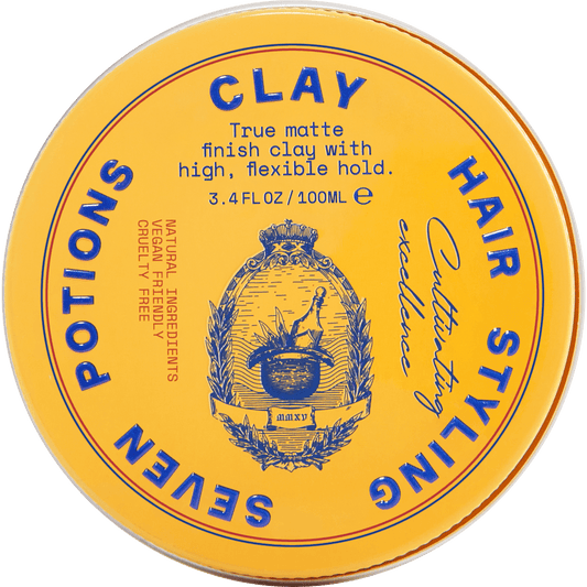 Yellow container of hair styling clay with branding and product details.
