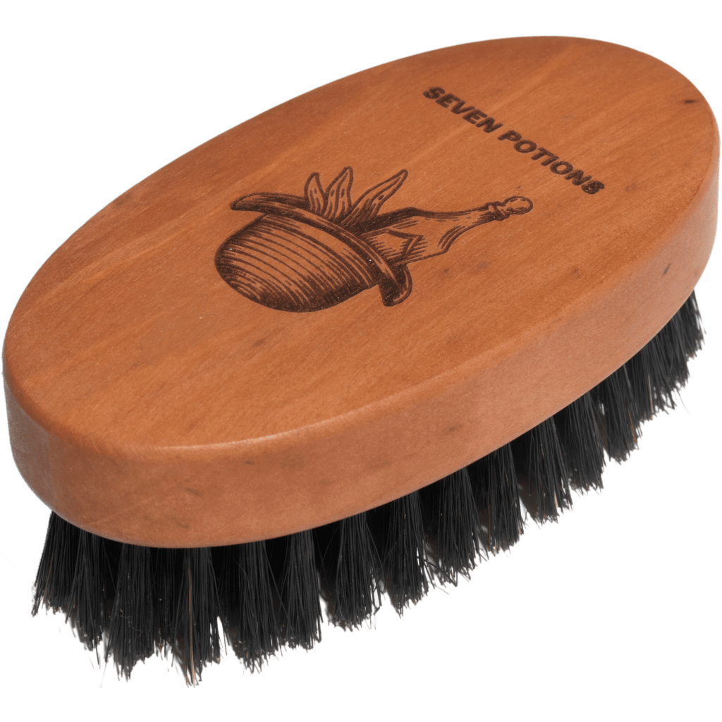 Wooden brush with black bristles and 'Seven Potions' branding on a transparent background