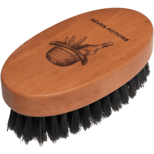 Wooden brush with black bristles and 'Seven Potions' branding on a transparent background