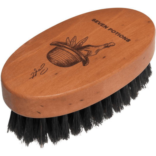 Wooden brush with black bristles and 'Seven Potions' branding on a clear background