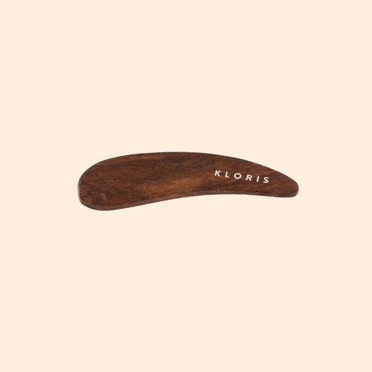 Wooden tool with 'KLORIS' branding on a beige background