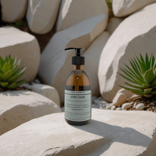 Bottle of 'Joint Ease' product on a rock with succulents in the background