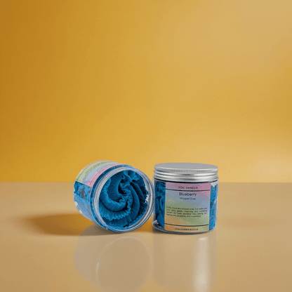 Two containers with blue rolled-up towels on a yellow background