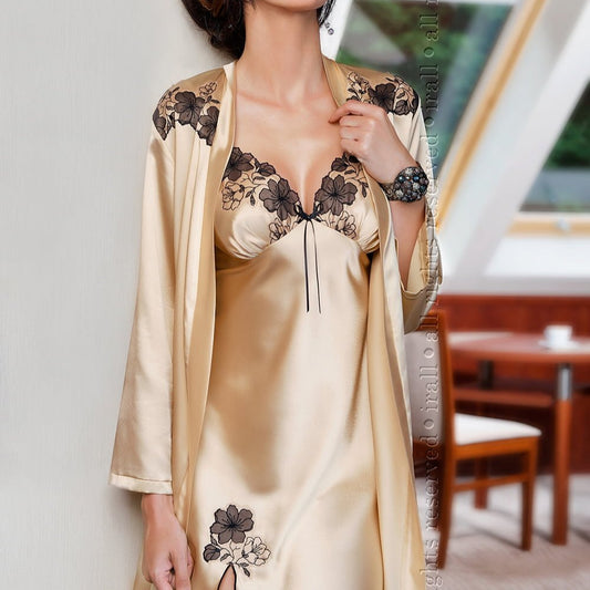lady wearing a champagne nightdress in front of table and chairs and window.