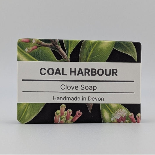 Bar of Coal Harbour Clove Soap with a label on a gray background
