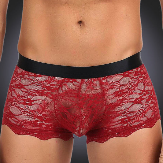 man wearing red briefs on grey background.