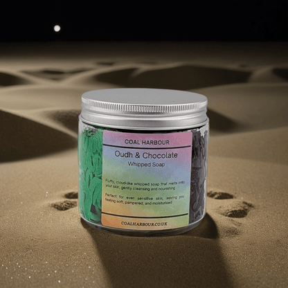 Jar of Coal Harbour Oudh & Chocolate Whipped Soap on sand with moonlit sky