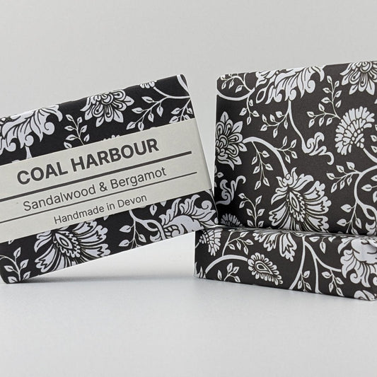 Two soap bars with black and white floral patterns on a light gray background