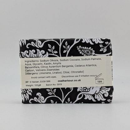 Bar of soap with black and white label on a gray background