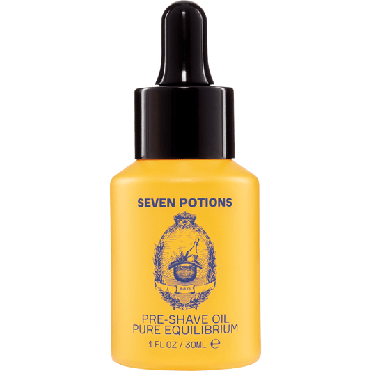 Yellow bottle of Seven Potions pre-shave oil with black dropper on a light gray background