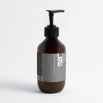 Brown bottle with pump and label on a white background
